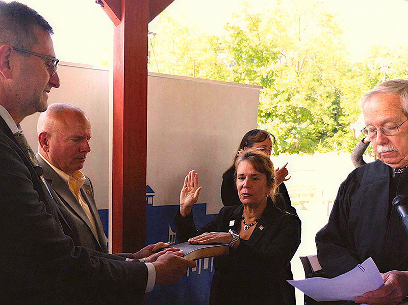 Delaware Secretary of Veterans Affairs Karen Berry takes the oath of office at the Delaware Veterans Home as Gov. Matt Meyer holds the bible.