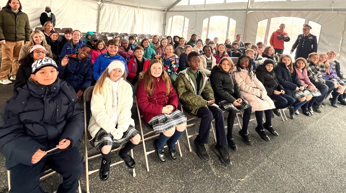 Fourth grade students from Holy Cross Elementary School in Dover DE learn about the reason for the Wreaths Across America event from Delaware legislators and military leaders.